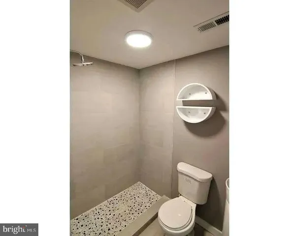 a bathroom with a toilet and a vanity