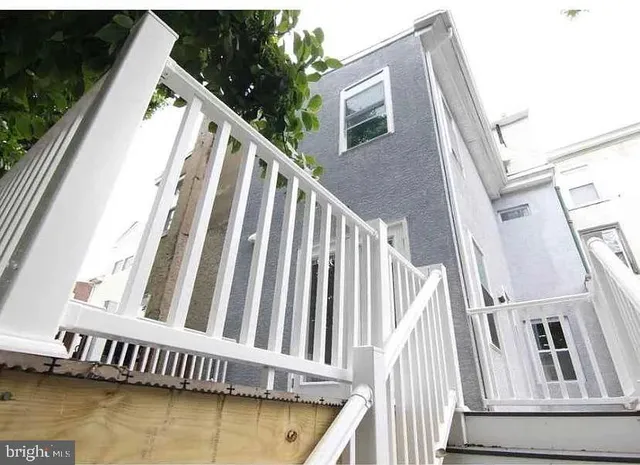 a view of balcony with wooden floor and fence