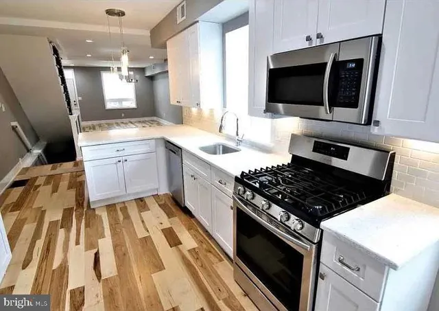 a kitchen with a stove and a microwave