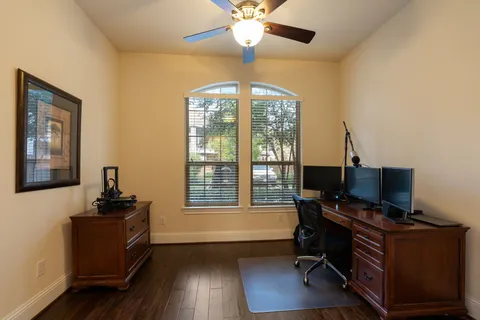 a view of a workspace with furniture and a window