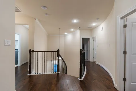 a view of hallway with wooden floor