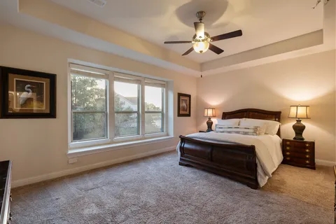 a spacious bedroom with a bed and a large window
