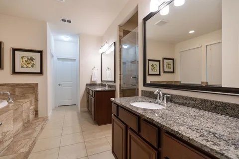a bathroom with a granite countertop sink a mirror and a
