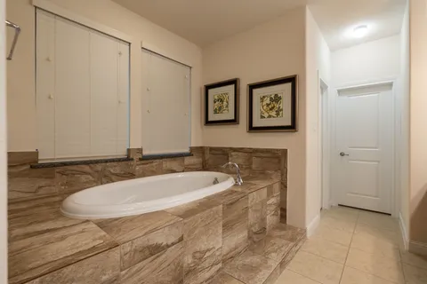 a bath tub sitting next to a bathroom sink