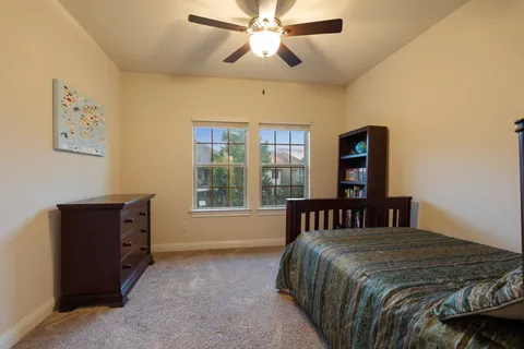 a bedroom with a bed dresser and a window