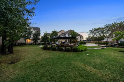 a view of a house with backyard and a tree