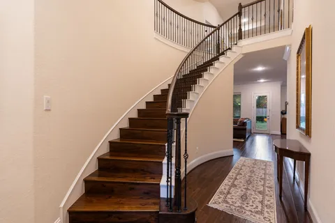 a view of entryway and hall with wooden floor
