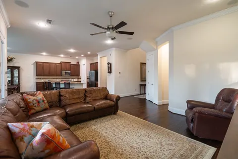 a living room with furniture and kitchen view