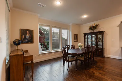 a dining room with furniture and wooden floor
