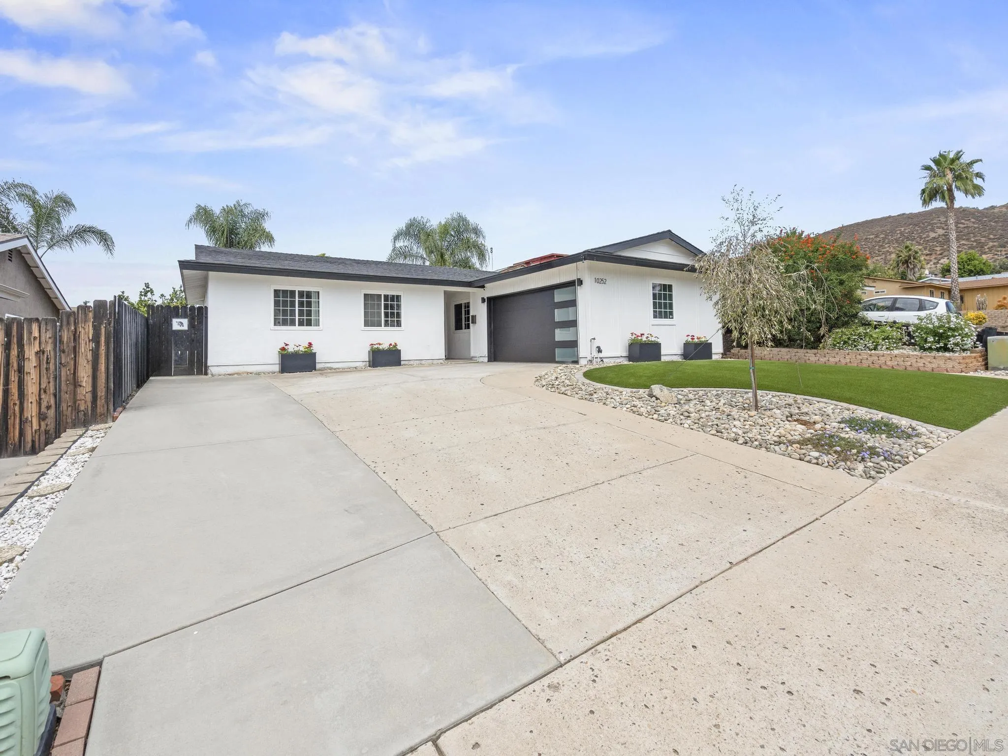 10252 Santana Street Santee, CA 92071 - Photo 2 of 21 a big house with a big yard and large trees