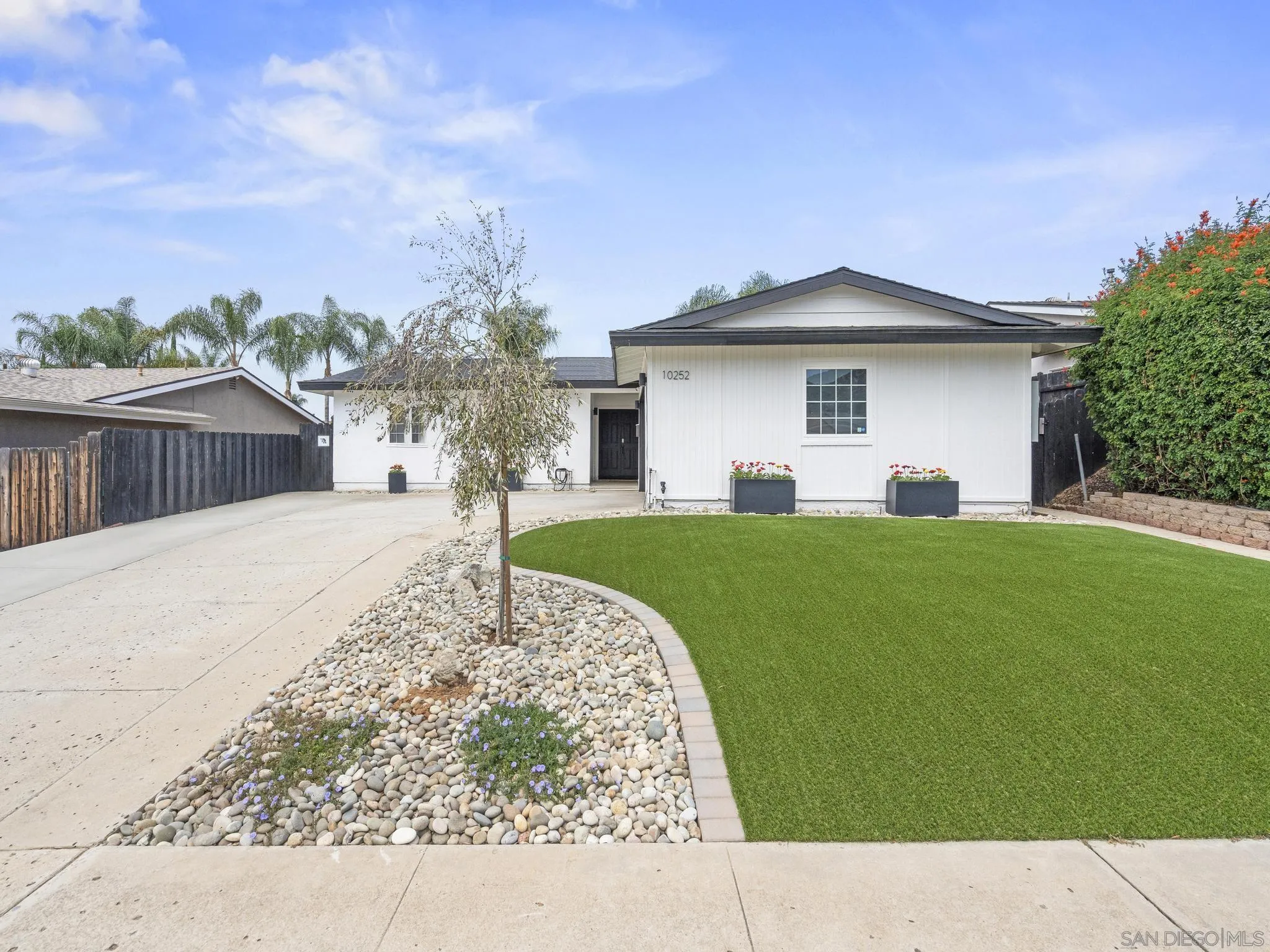 10252 Santana Street Santee, CA 92071 - Photo 3 of 21 a front view of a house with garden