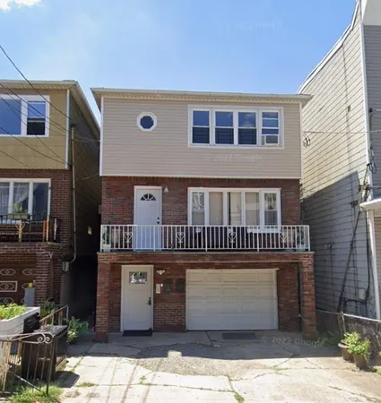 a front view of a house with parking