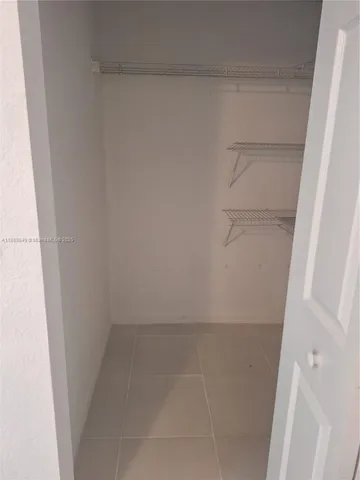 a white toilet sitting next to a bath tub and a shower