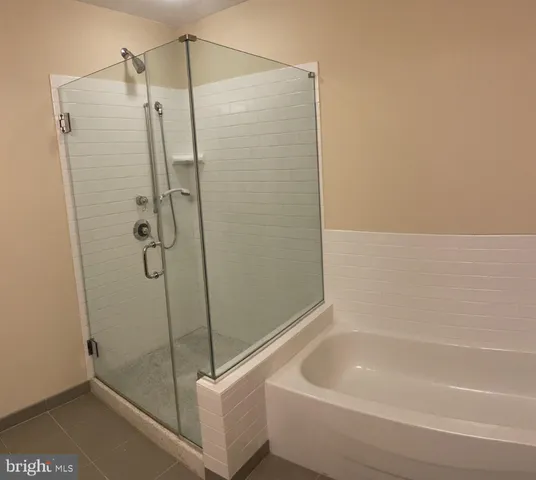 a bathroom with a double vanity sink toilet and shower
