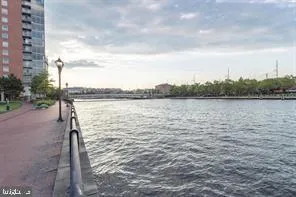 a view of swimming pool with outdoor seating and lake view