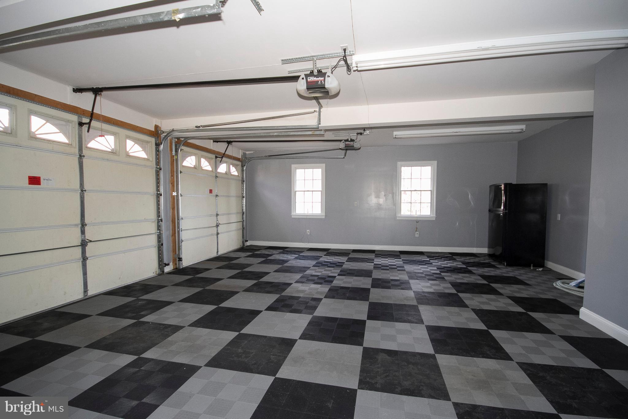 3028 Shepperd Road Monkton, MD 21111 - Photo 21 of 23 a room with a black white checkered floor with a gaming machine and wooden floor