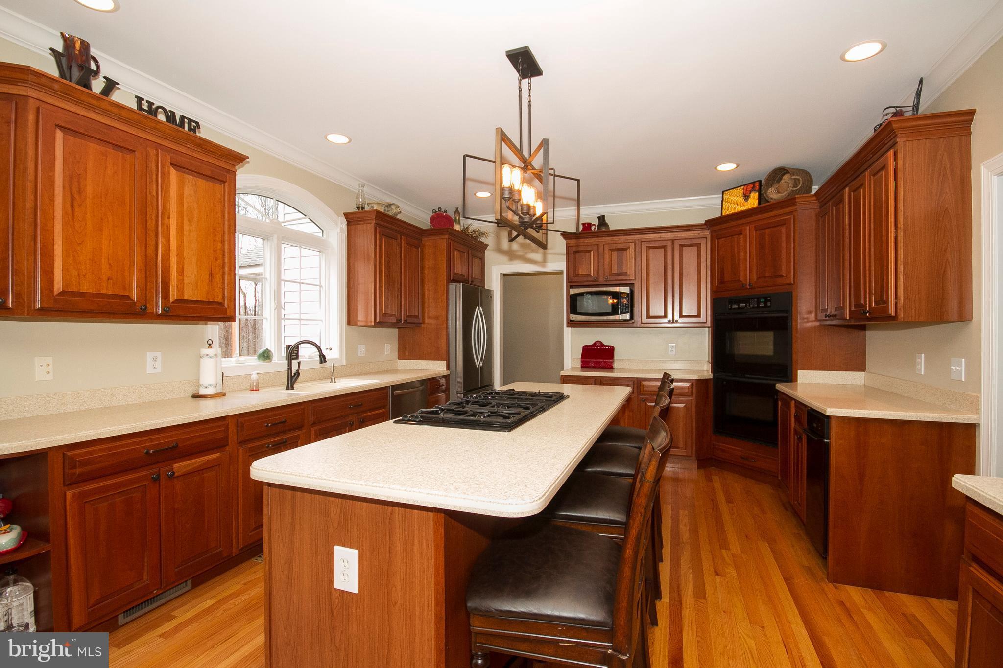 3028 Shepperd Road Monkton, MD 21111 - Photo 7 of 23 a kitchen with stainless steel appliances kitchen island granite countertop a sink dishwasher and cabinets with wooden floor