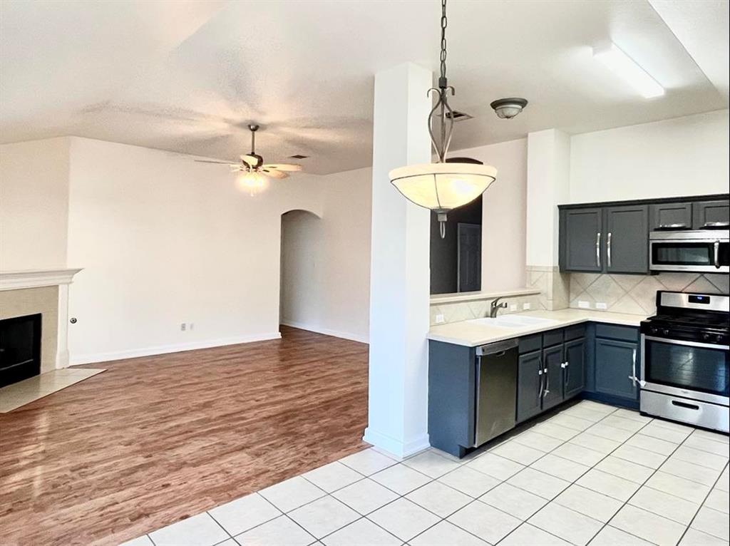 2409 Romeo Drive Cedar Park, TX 78613 - Photo 5 of 22 a kitchen with stainless steel appliances a sink cabinets and wooden floor