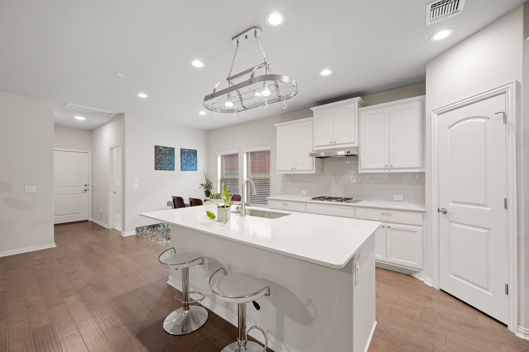 8800 Slater Drive Austin, TX 78747 - Photo 6 of 40 a kitchen with kitchen island granite countertop stainless steel appliances lots of counter top space and a sink