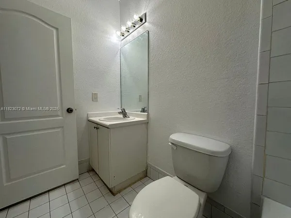 an empty room with wooden floor and a window