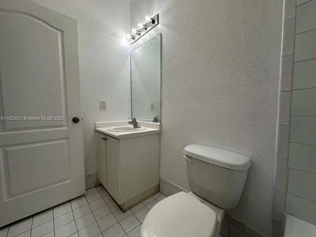 an empty room with wooden floor and a window