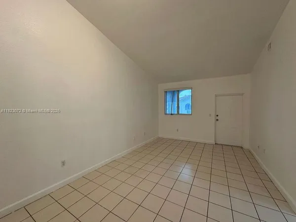 a white kitchen with granite countertop appliances a sink and cabinets
