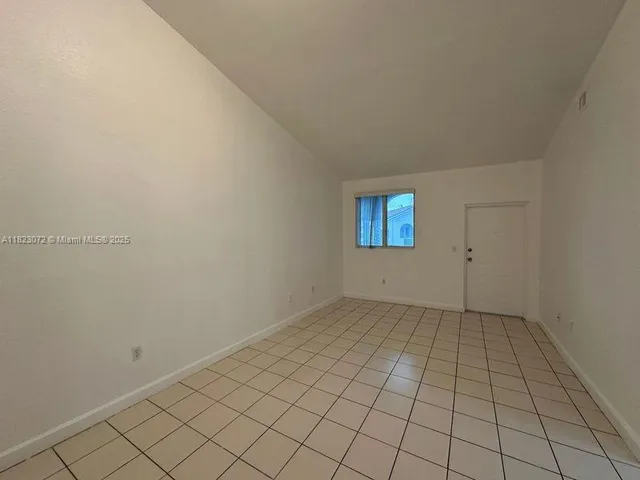 a white kitchen with granite countertop appliances a sink and cabinets