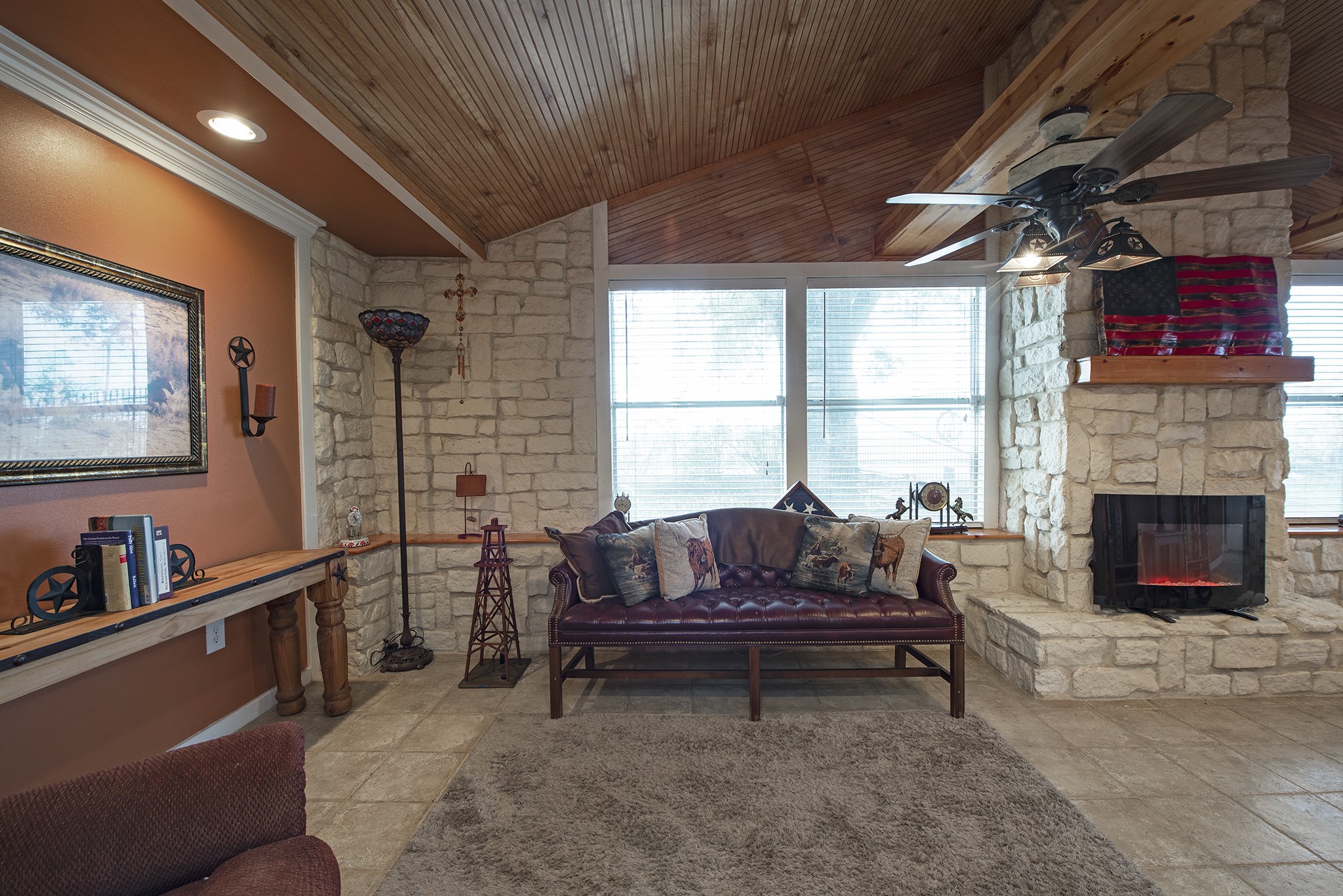 22234 Castle Road Waller, TX 77484 - Photo 16 of 50 a living room with furniture a flat screen tv and a fireplace