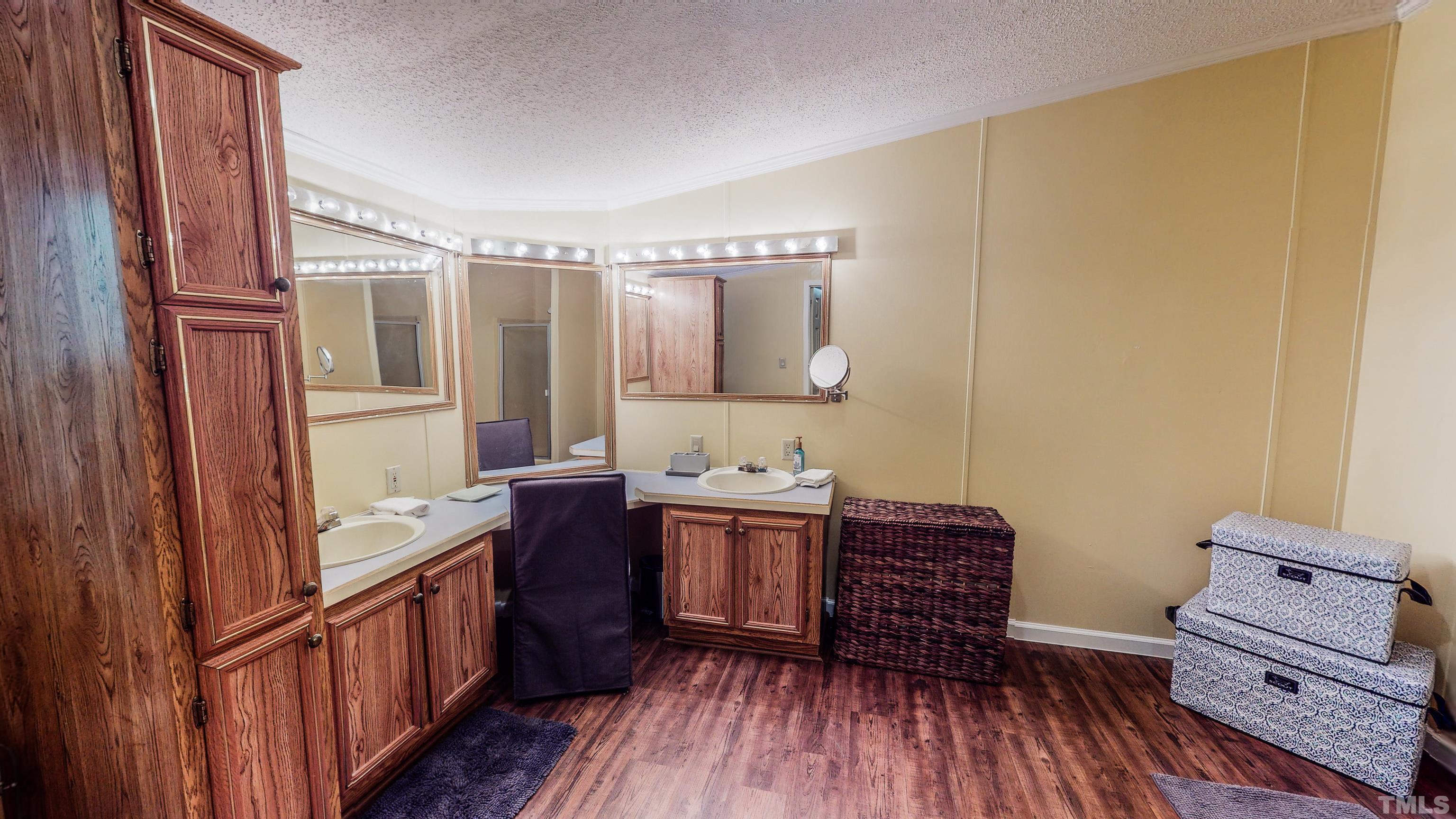893 Harris Mill Road Rougemont, NC 27572 - Photo 22 of 30 a bathroom with a double vanity sink and a mirror