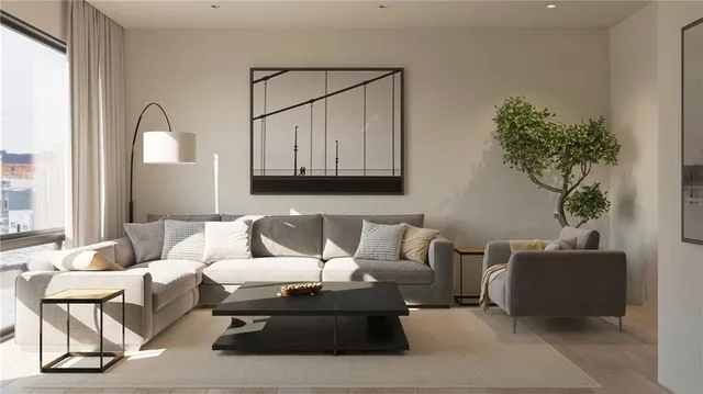 a living room with furniture and a potted plant