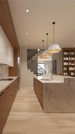 a large kitchen with stainless steel appliances a large counter top a stove and a sink