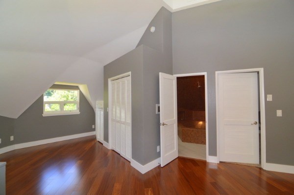 4624 Kuli Road Kalaheo, HI 96741 - Photo 19 of 25 an empty room with wooden floor and windows