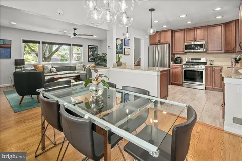 a kitchen with stainless steel appliances granite countertop a sink a stove and a refrigerator