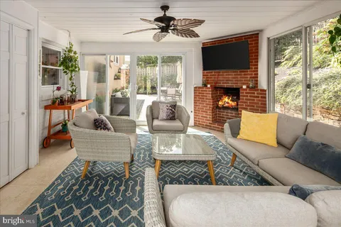 a living room with furniture fireplace and a large window