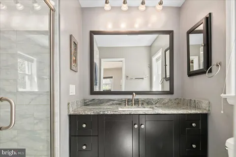 a bathroom with a granite countertop sink a mirror and a