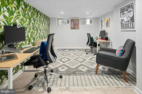 a work room with furniture and a laptop