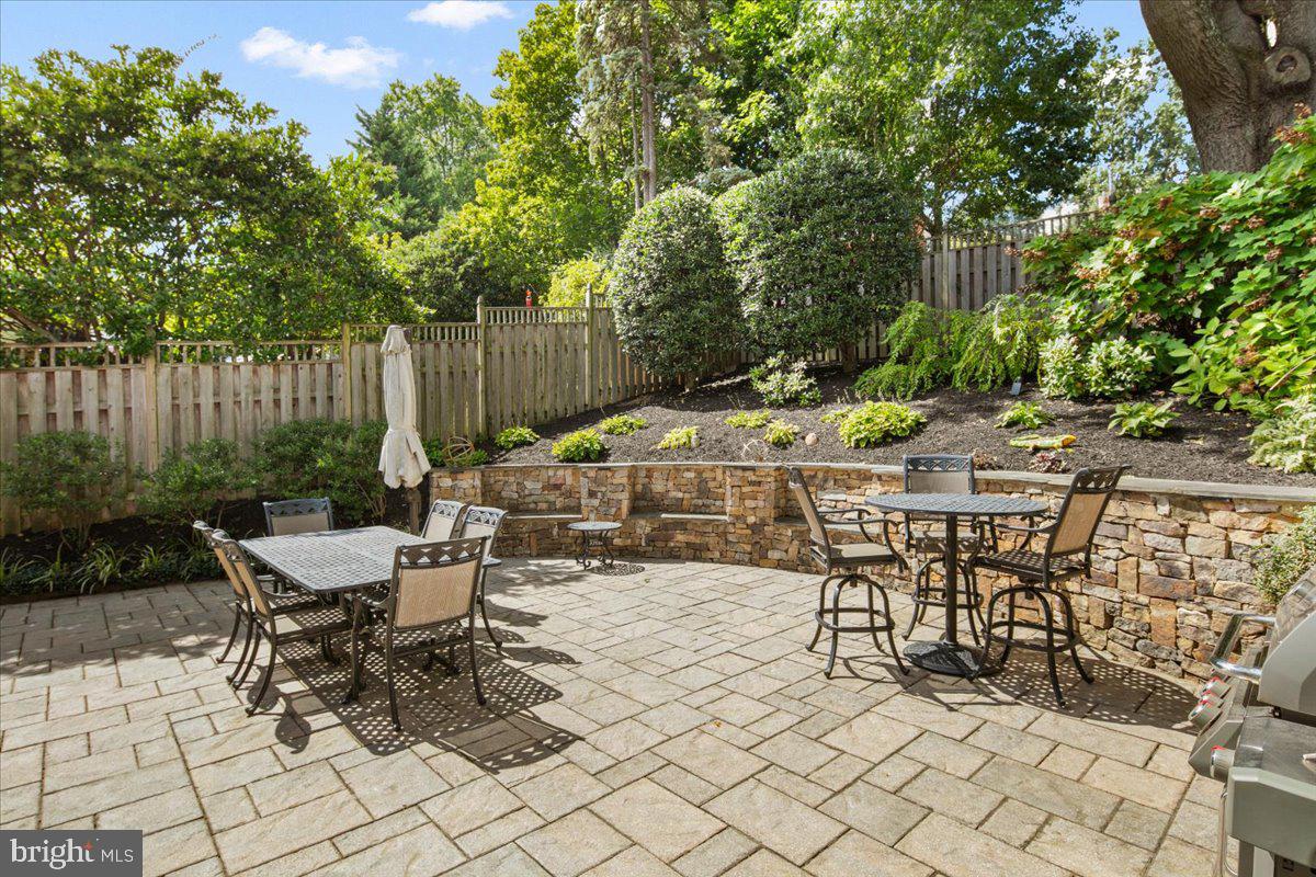 5913 4th Road North Arlington, VA 22203 - Photo 40 of 45 a view of a patio with table and chairs potted plants and wooden fence