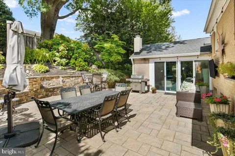 a view of a patio with table and chairs and potted plants