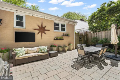a view of a patio with a dining table and chairs