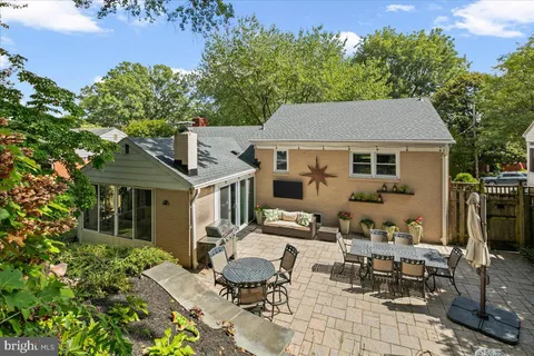 a view of a patio with table and chairs and potted plants