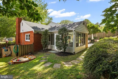 a view of a chair and table in backyard of the house
