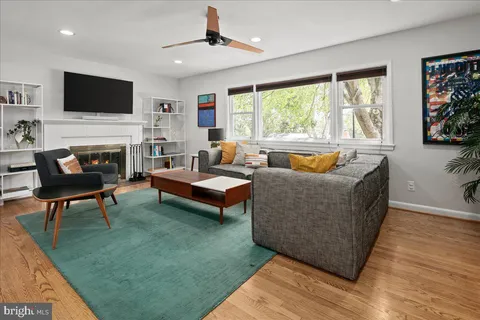 a living room with fireplace furniture and a flat screen tv
