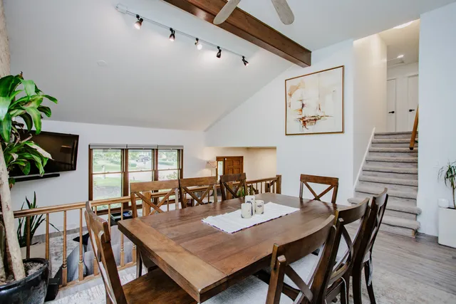 a view of a dining room with furniture and wooden floor
