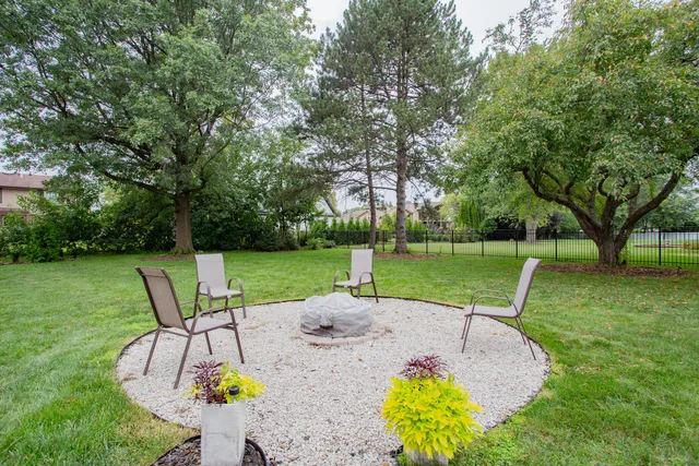 a view of a swimming pool with a garden and slide