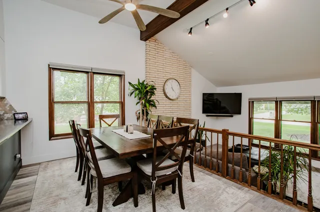 a view of a dining room with furniture and a window