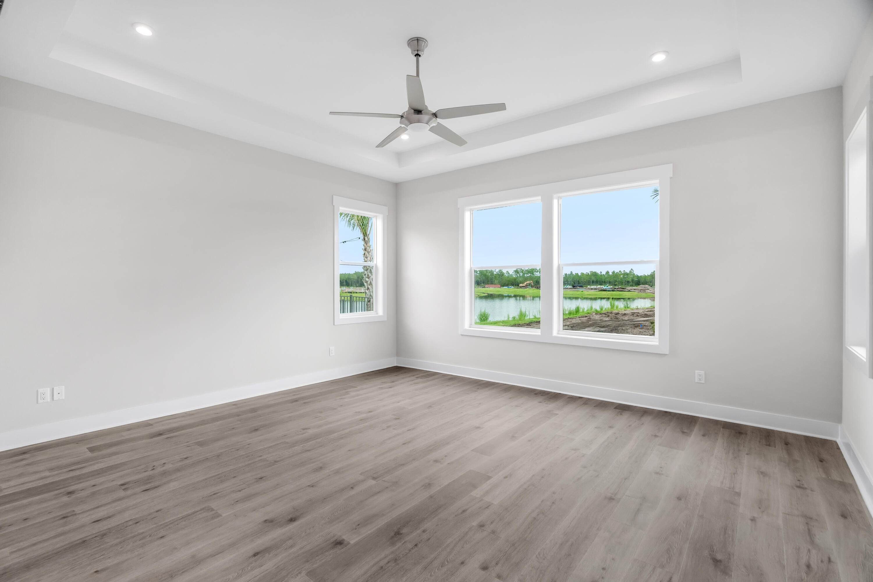 30 River Rise Way Inlet Beach Inlet Beach, FL 32461 - Photo 34 of 61 an empty room with wooden floor chandelier fan and windows