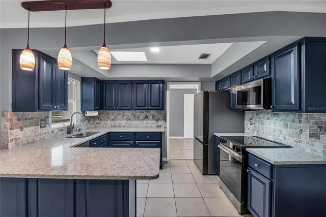 a kitchen with a refrigerator and a sink