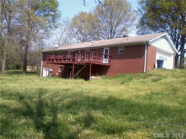 5879 Alexander Road Concord, NC 28027 - Photo 2 of 7 a view of a house with a yard and a large tree