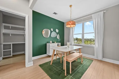 a view of a dining room with furniture window and wooden floor