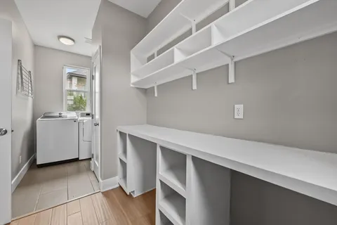 a utility room with cabinets washer and dryer